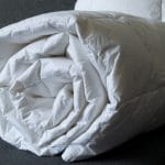 Detail of a rolled white down comforter