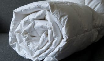 Detail of a rolled white down comforter